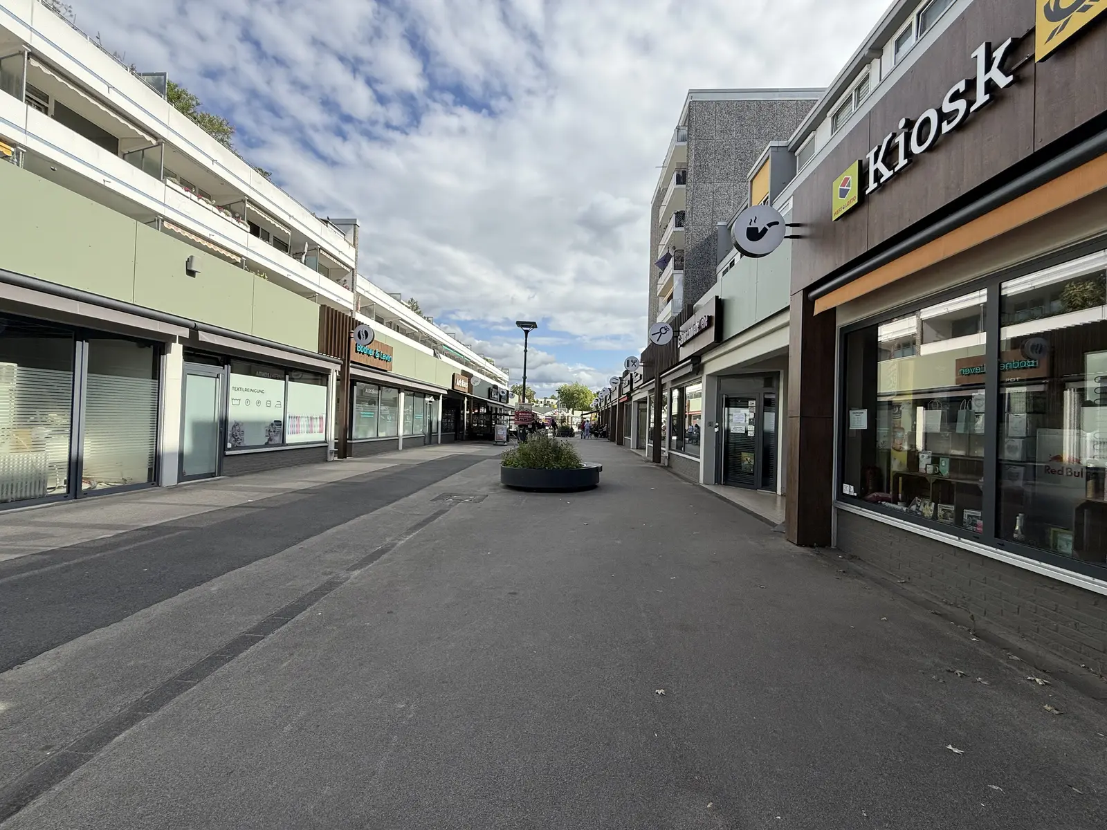 Die Holzweg-Passage in Baumberg mit ihren Geschäften an einem sonnigen Tag